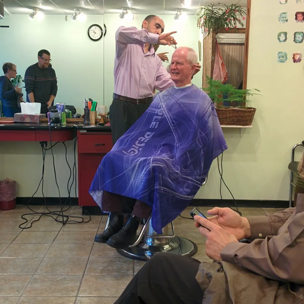 A customer in the barber chair at Opus