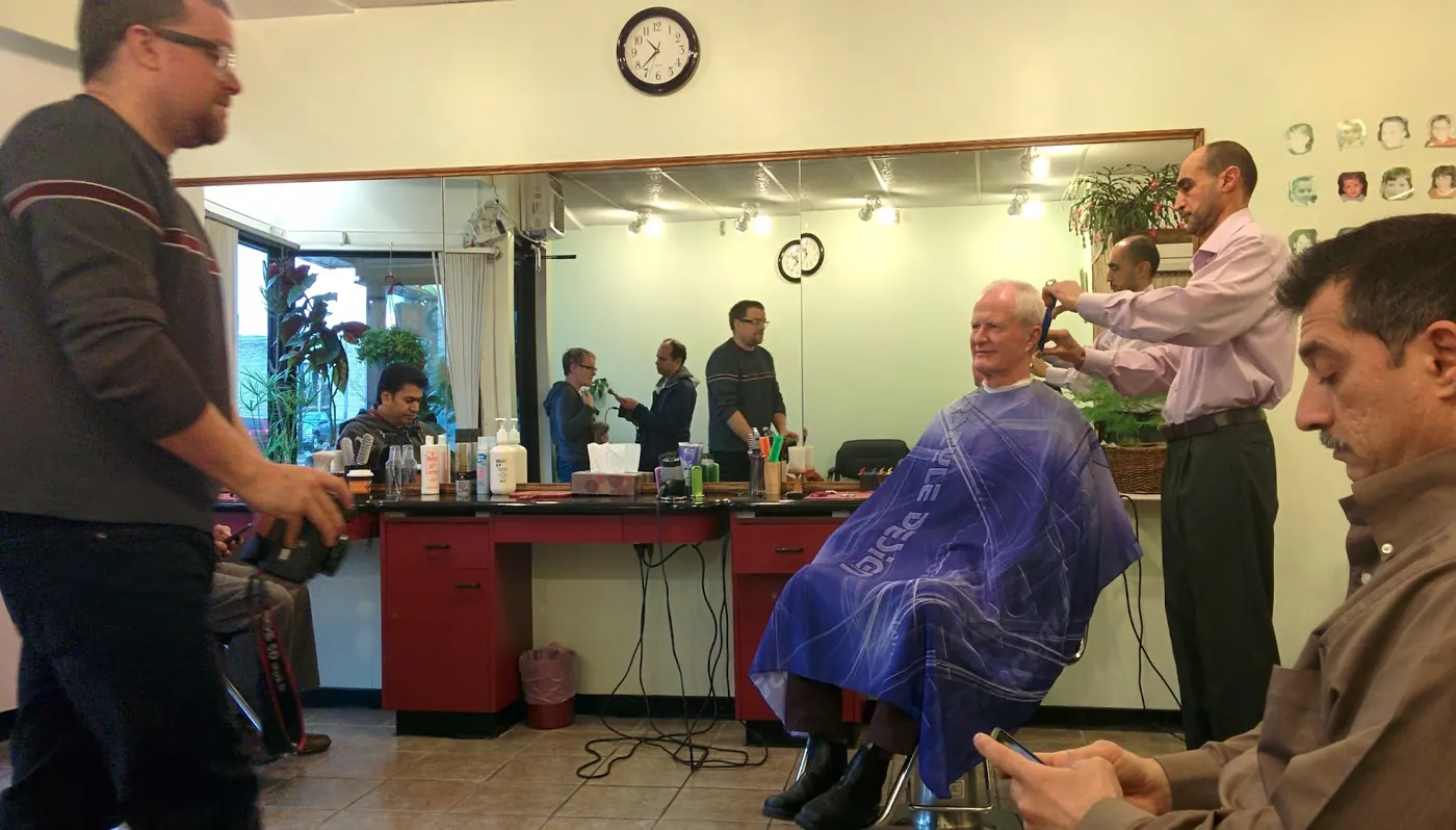 Inside Opus Barber Shop: barber chairs, mirrors and a wall clock